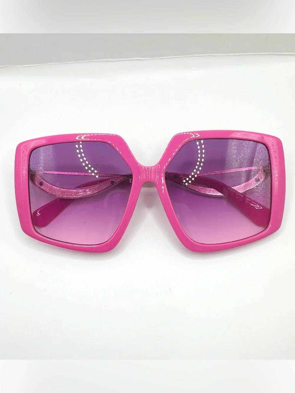Oversized pink Hollywood square sunglasses feature bold glossy frames